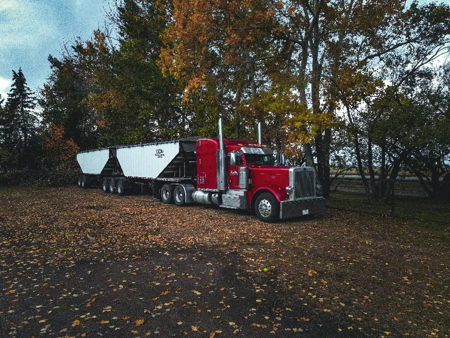 A huge red trailer truck parked on the road