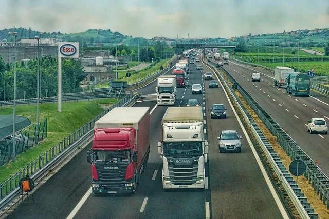 Cars passing near two trucks