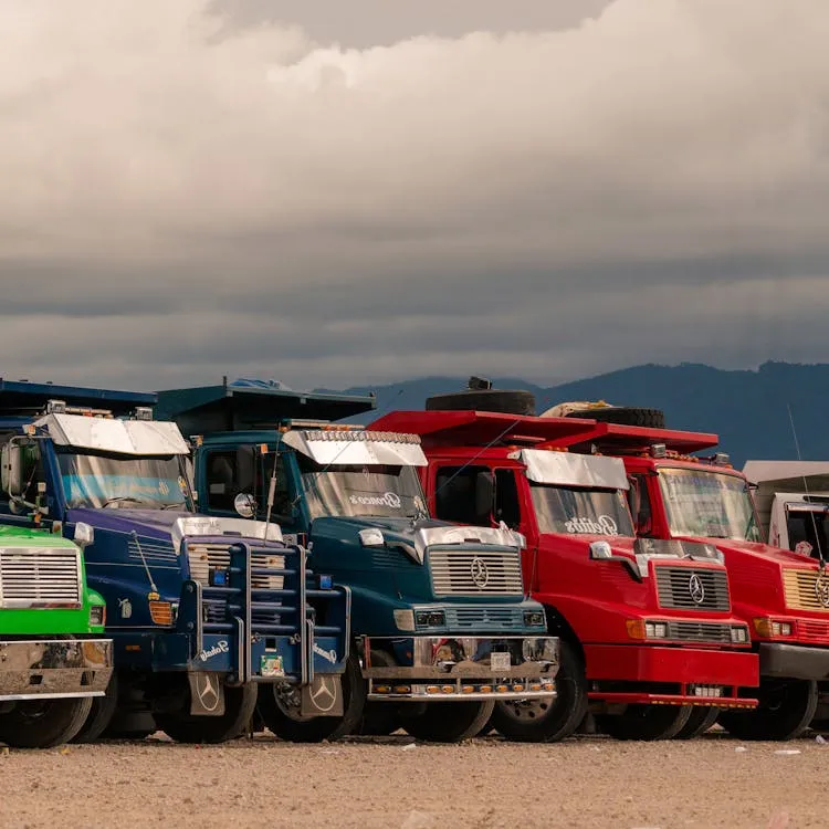 Several colorful trucks parked in an open space.