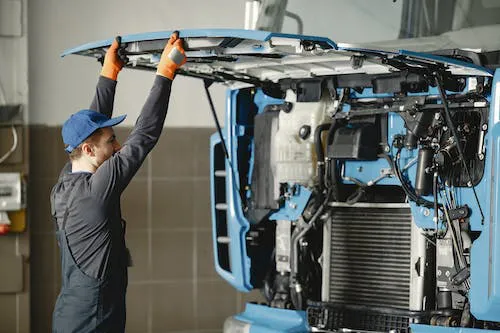 Mechanic inspecting truck before CDL testing