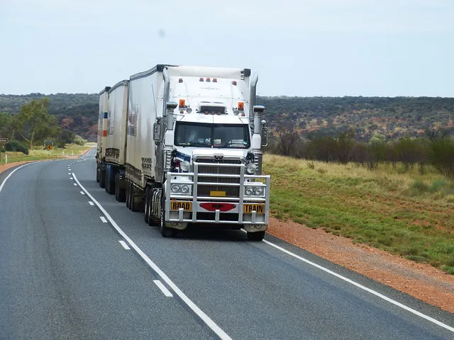 A semi-trailer truck on a smooth road during daytime