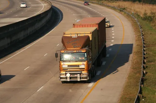 A semi-trailer truck on a smooth road during daytime