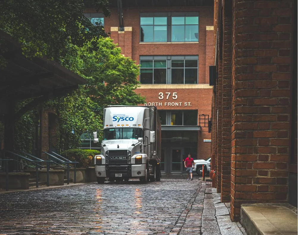 A truck driver driving a 6-wheeler on the road