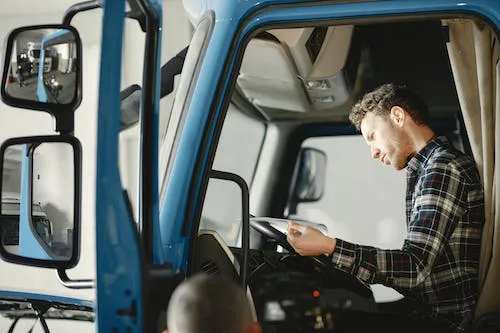 A truck driver reading truck driving manual