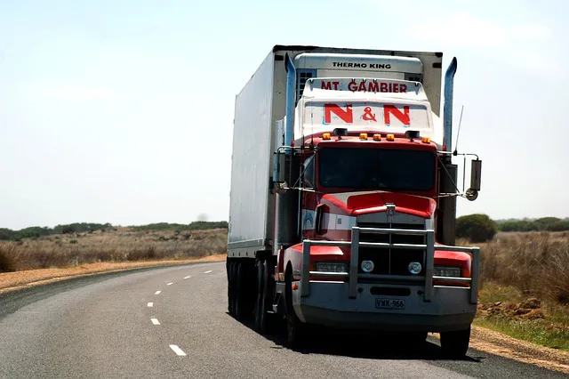 A semi-trailer truck on a smooth highway during daytime