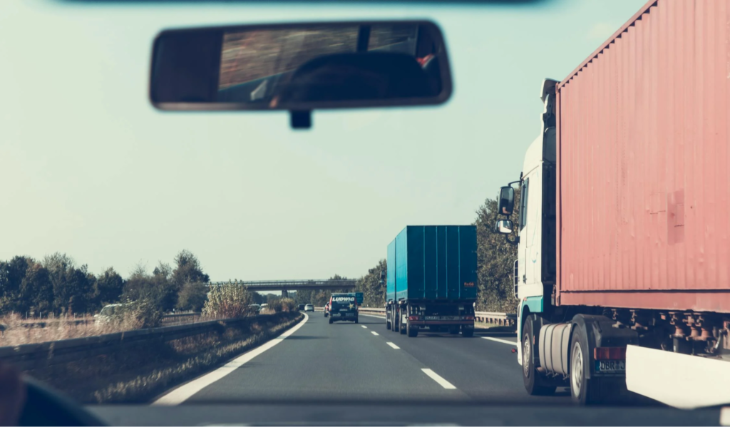 Blue and red freight trucks on the road
