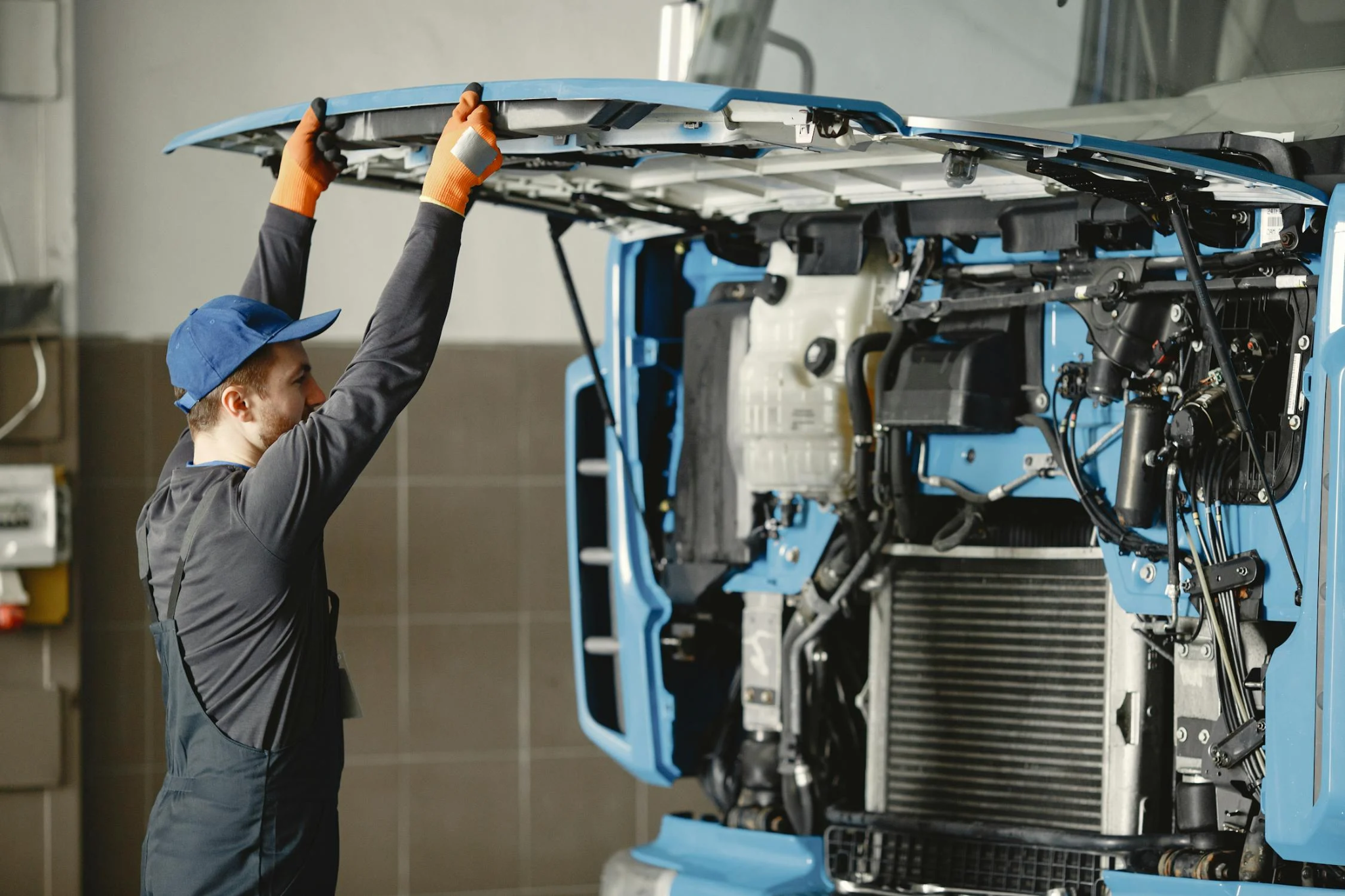 A truck driver inspecting the insides of a truck