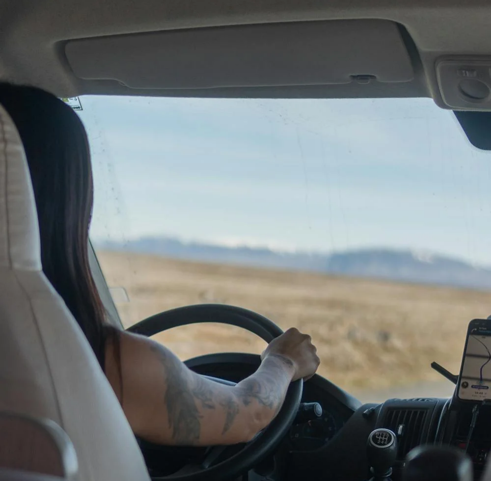 Brunette woman driving a truck