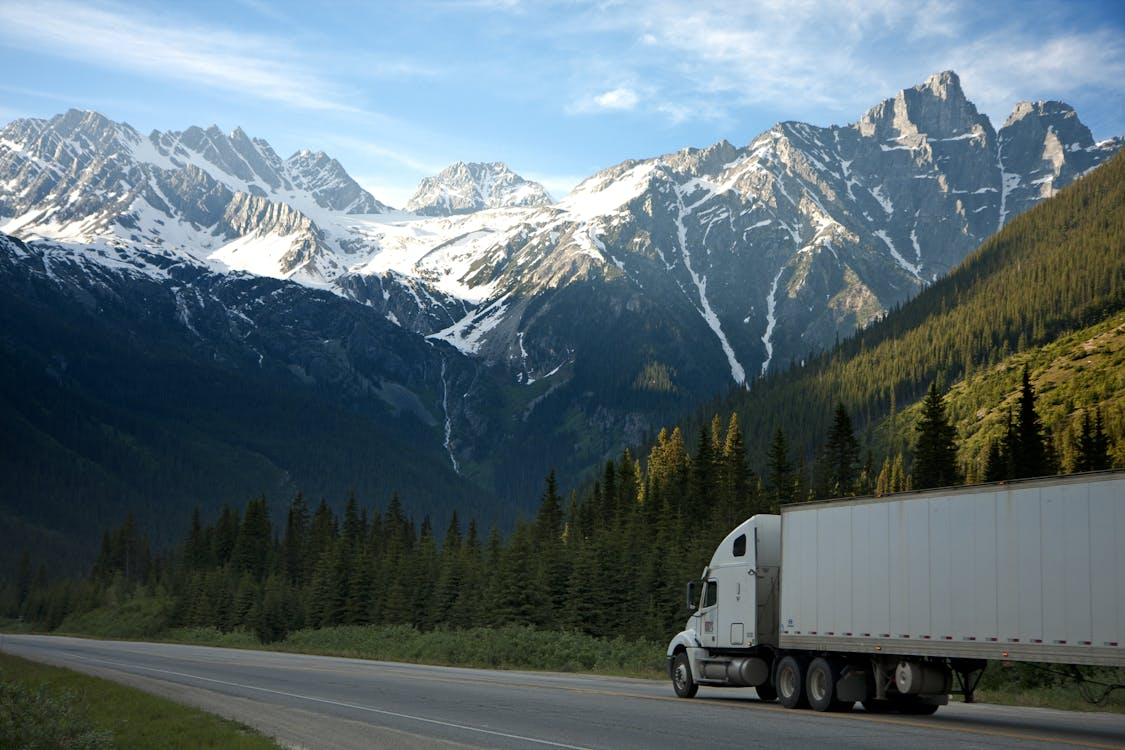 A commercial truck driving through the mountains