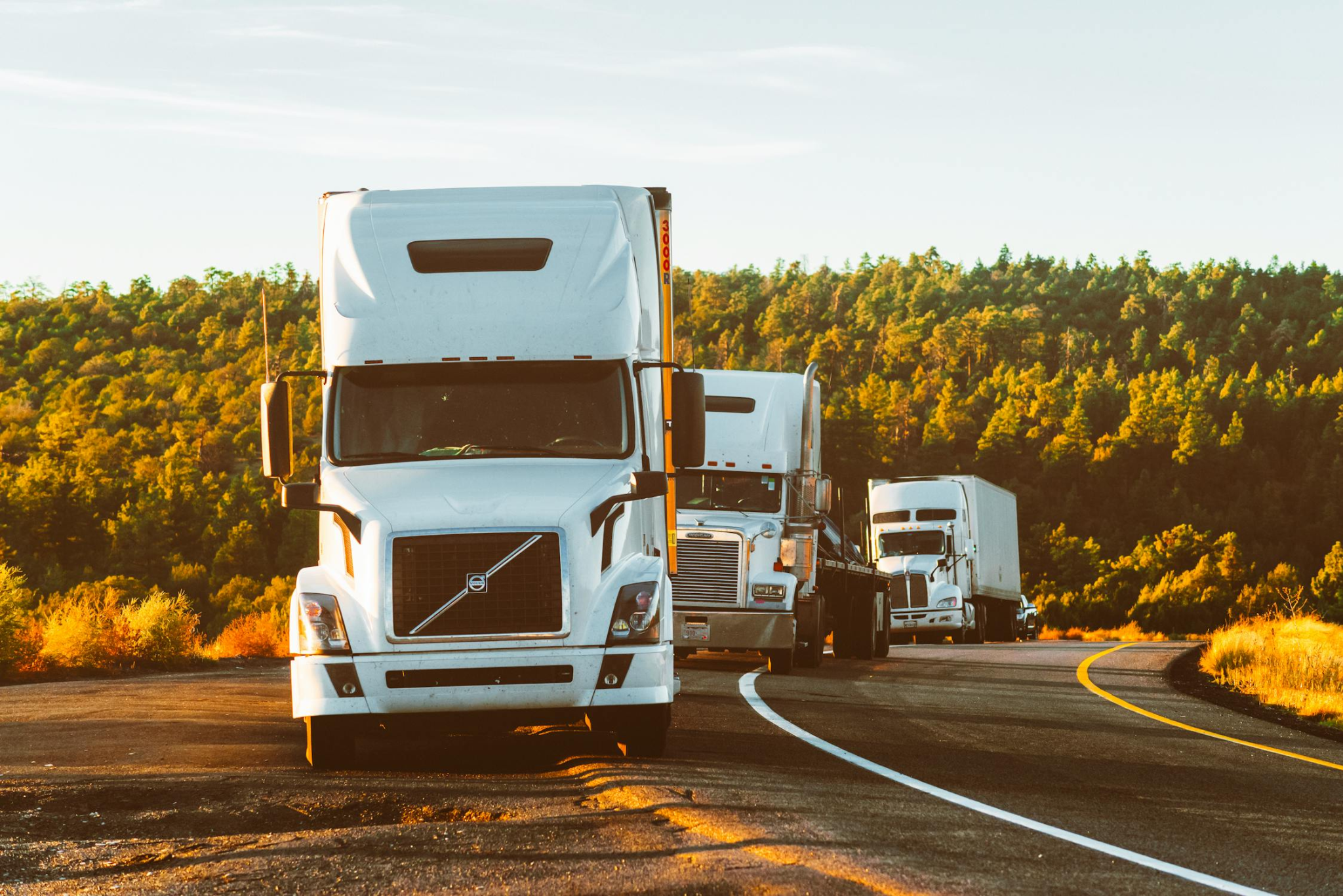 Three trucks on a road