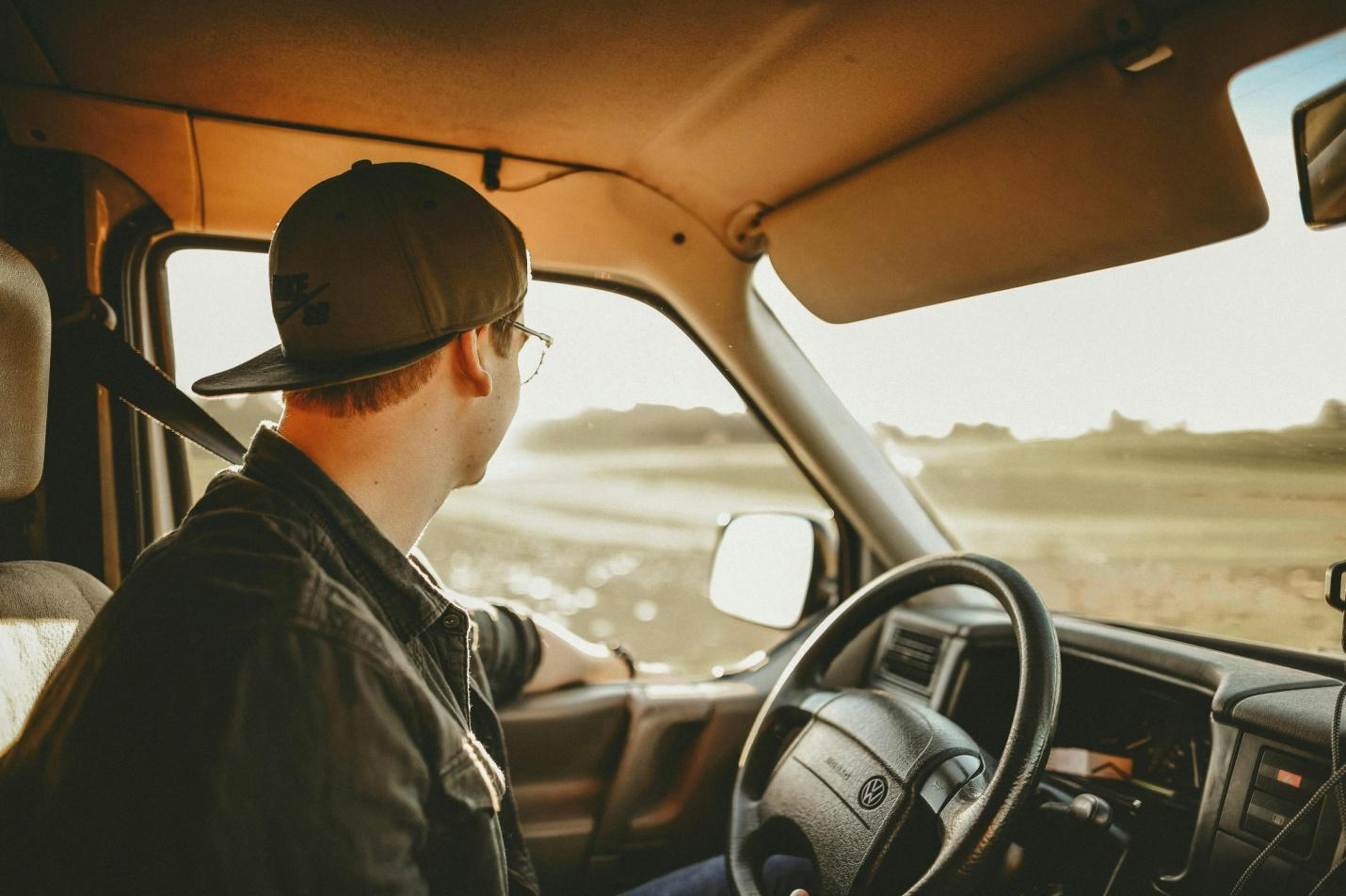 A picture of a truck driver in driver's seat