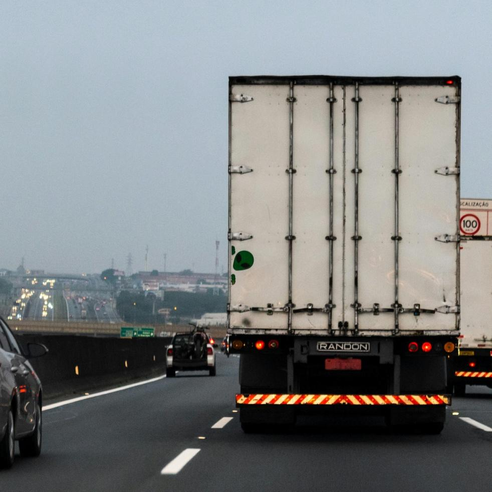 A picture of the back of a truck on the road