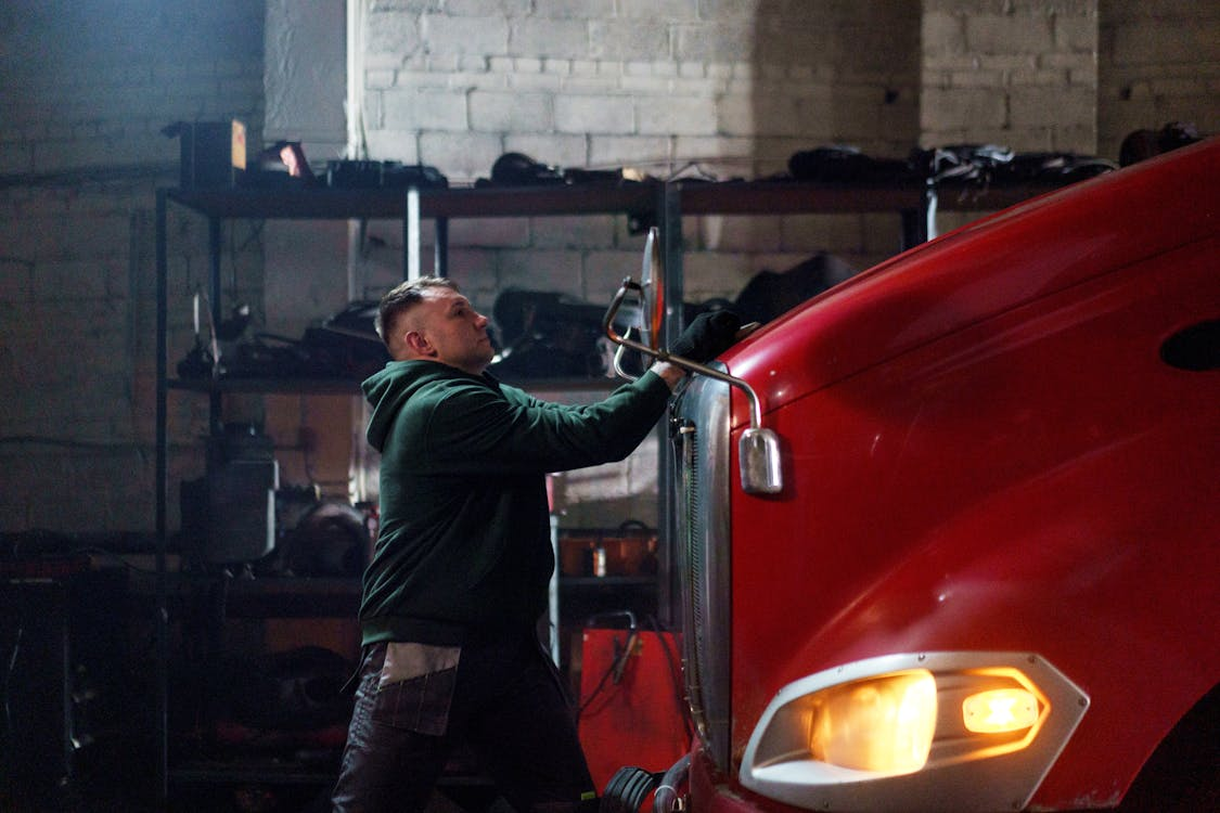 A commercial driver cleaning their truck before a journey