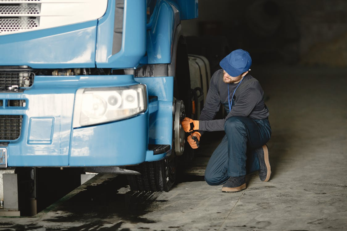 A CDL training student checking tires as a part of training