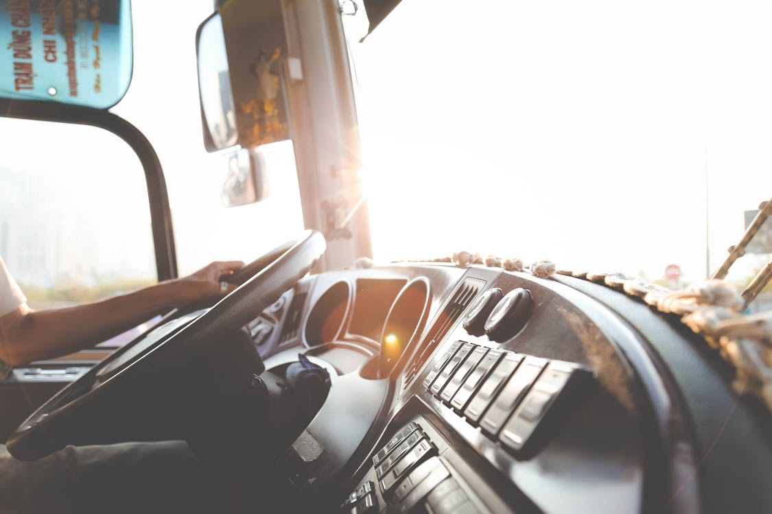 Cropped photo of a person driving a truck