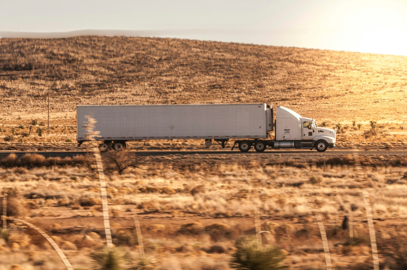 A truck driving through a dry landscape