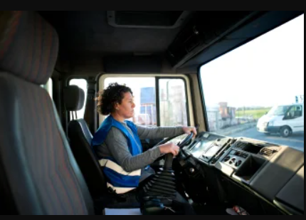 A person driving a large commercial truck.