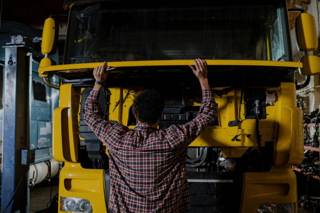 A person inspecting a truck before their trip