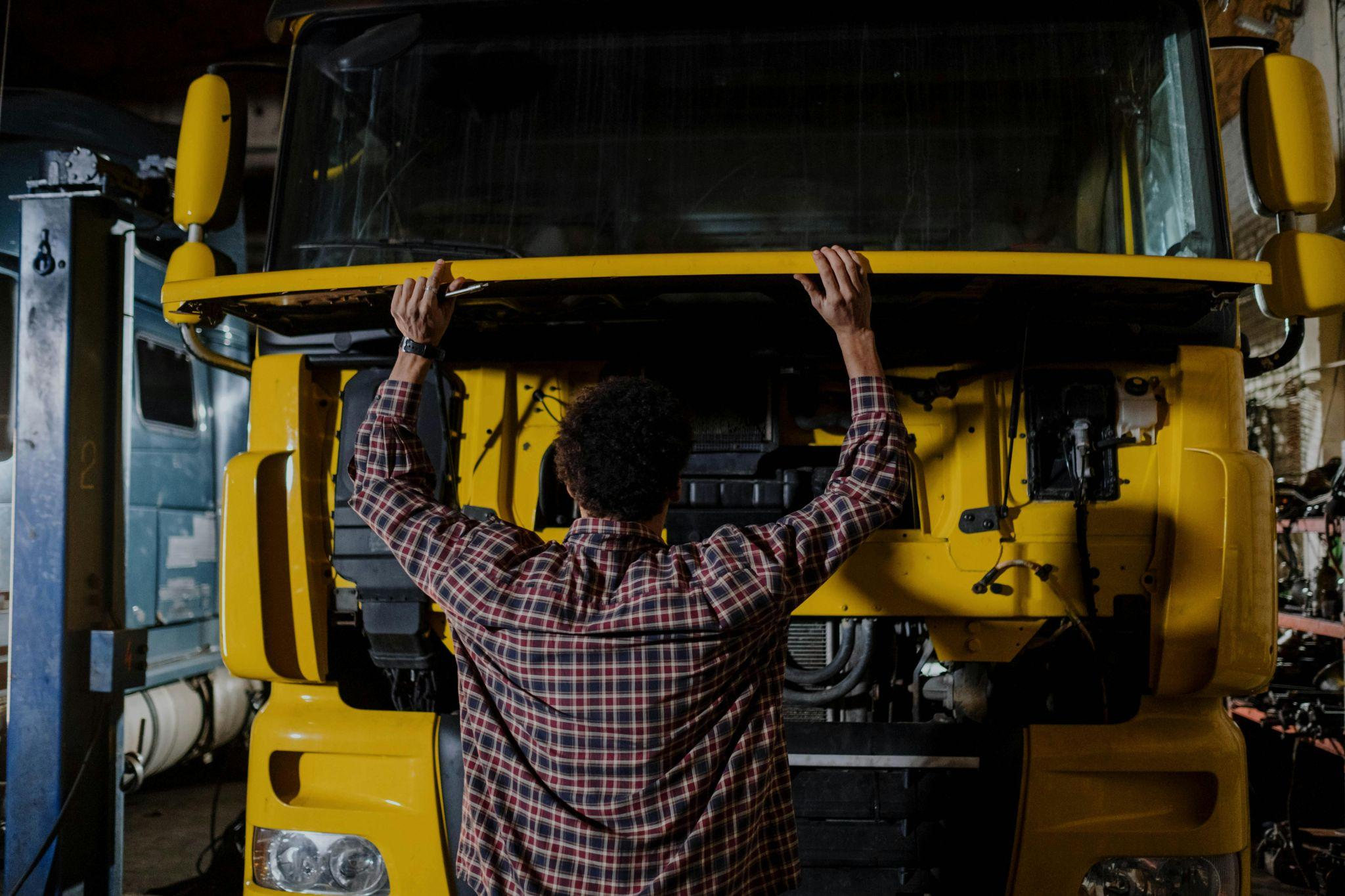 A person inspecting a truck before their trip