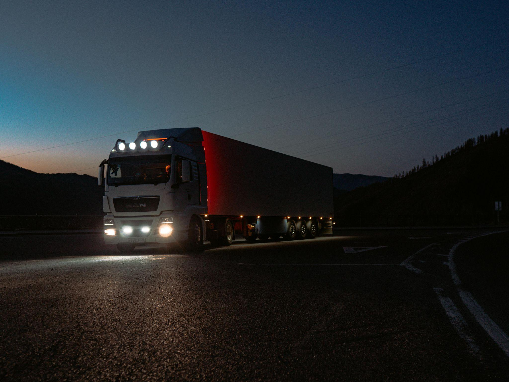 A truck driving by at night
