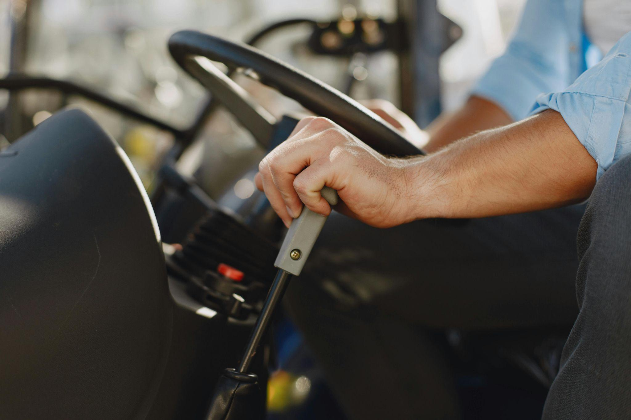A driver sitting with his hand on a gear