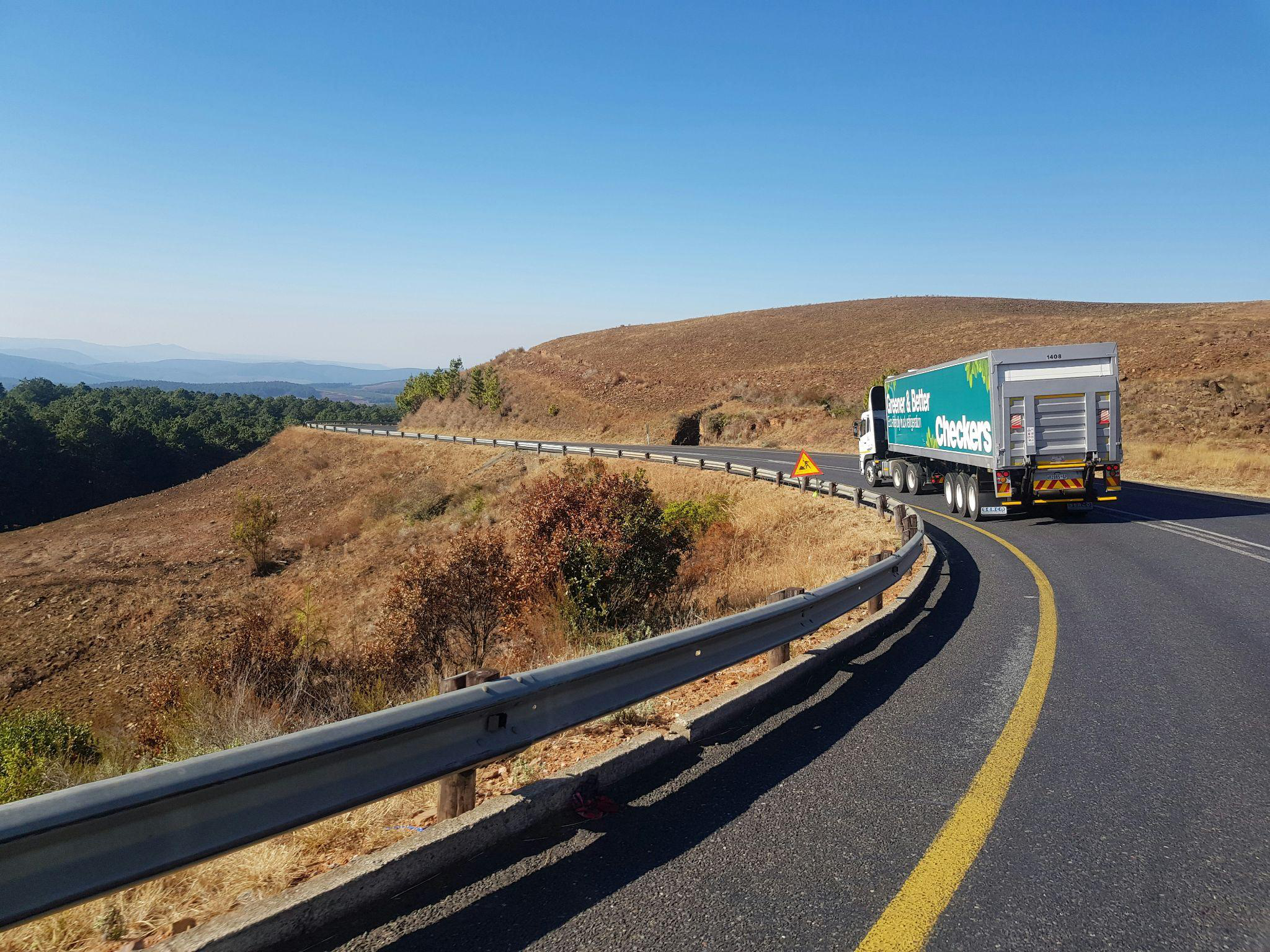 a truck driving down a road