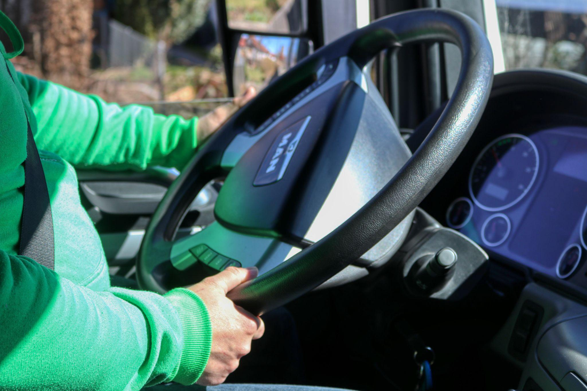 a truck driver sitting behind the steering wheel