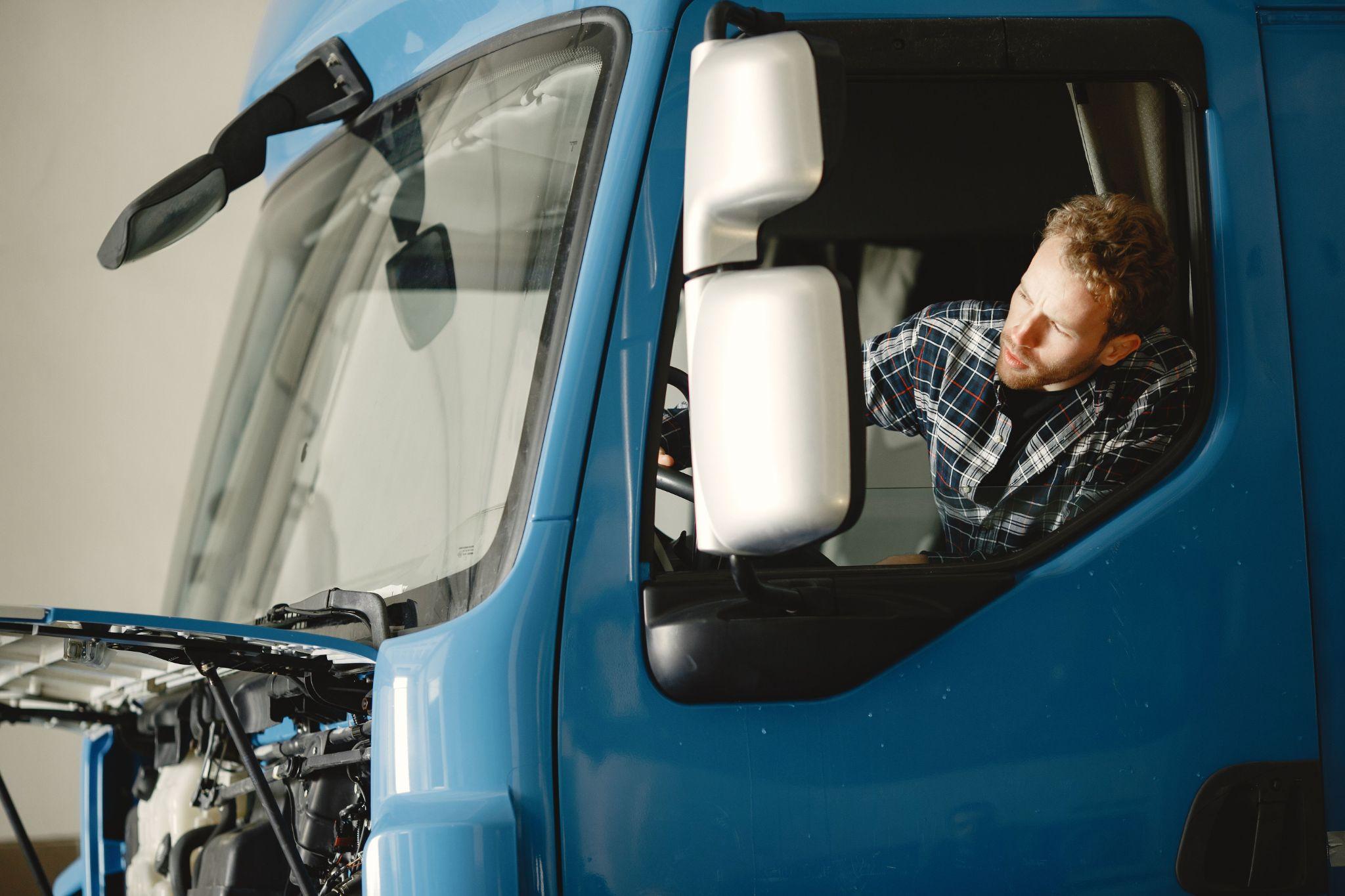 A driver checking a truck before driving
