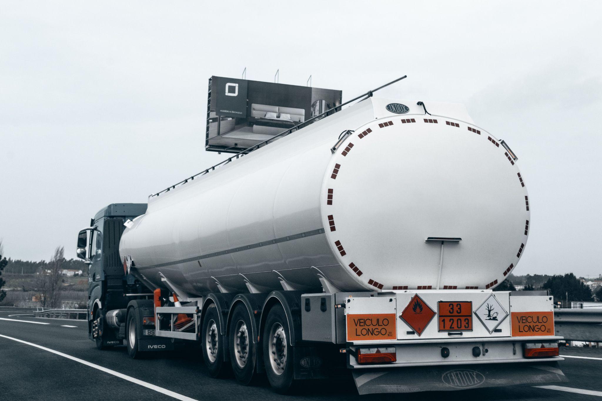 a truck carrying fuel driving on a highway